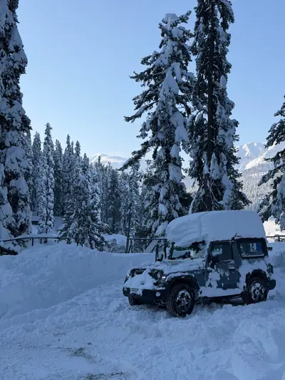 Snow-covered 4x4 SUV ready for mountain transfers